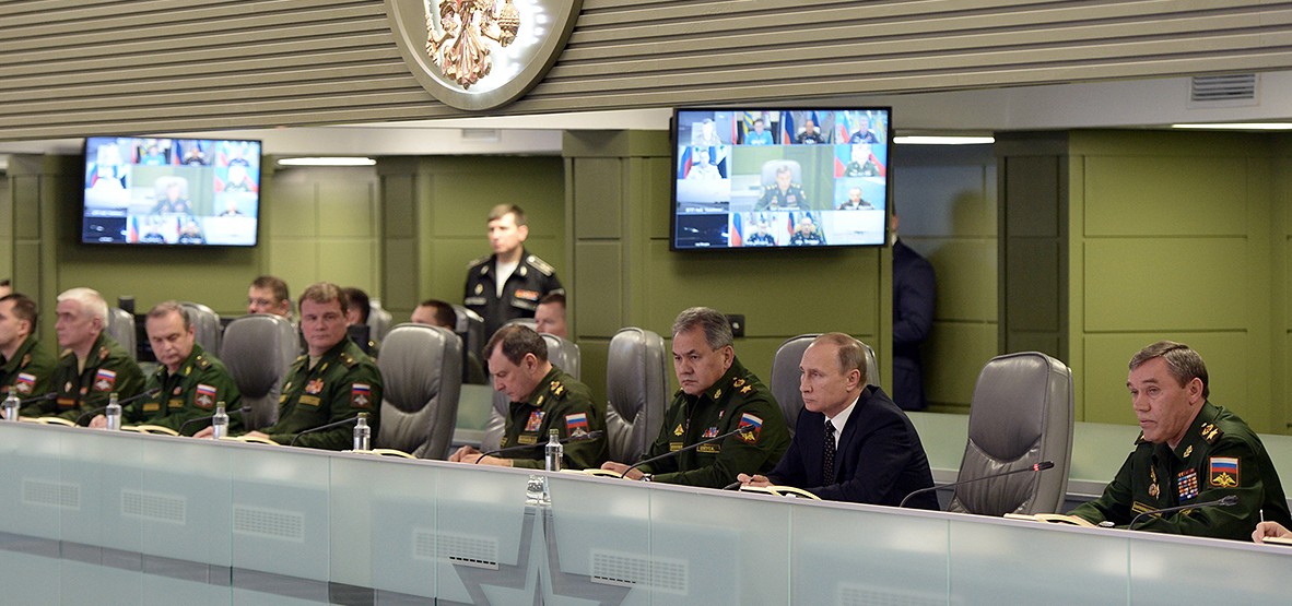 Russian President Vladimir Putin, second right, flanked by Defense Minister Sergei Shoigu, third right, and Chief of the General Staff of the Russian Armed Forces Valery Gerasimov, right, attends a meeting on Russian airspace forces' activities in Syria, as he visits the National Defense Control Center in Moscow, Tuesday, Nov. 17, 2015. (Alexei Nikolsky/SPUTNIK, Kremlin Pool Photo via AP)